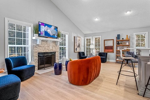 a living room with a fireplace and a tv